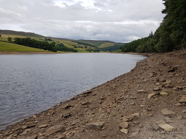 Nusekusi Ladybower užtvanka su žaliomis kalvomis